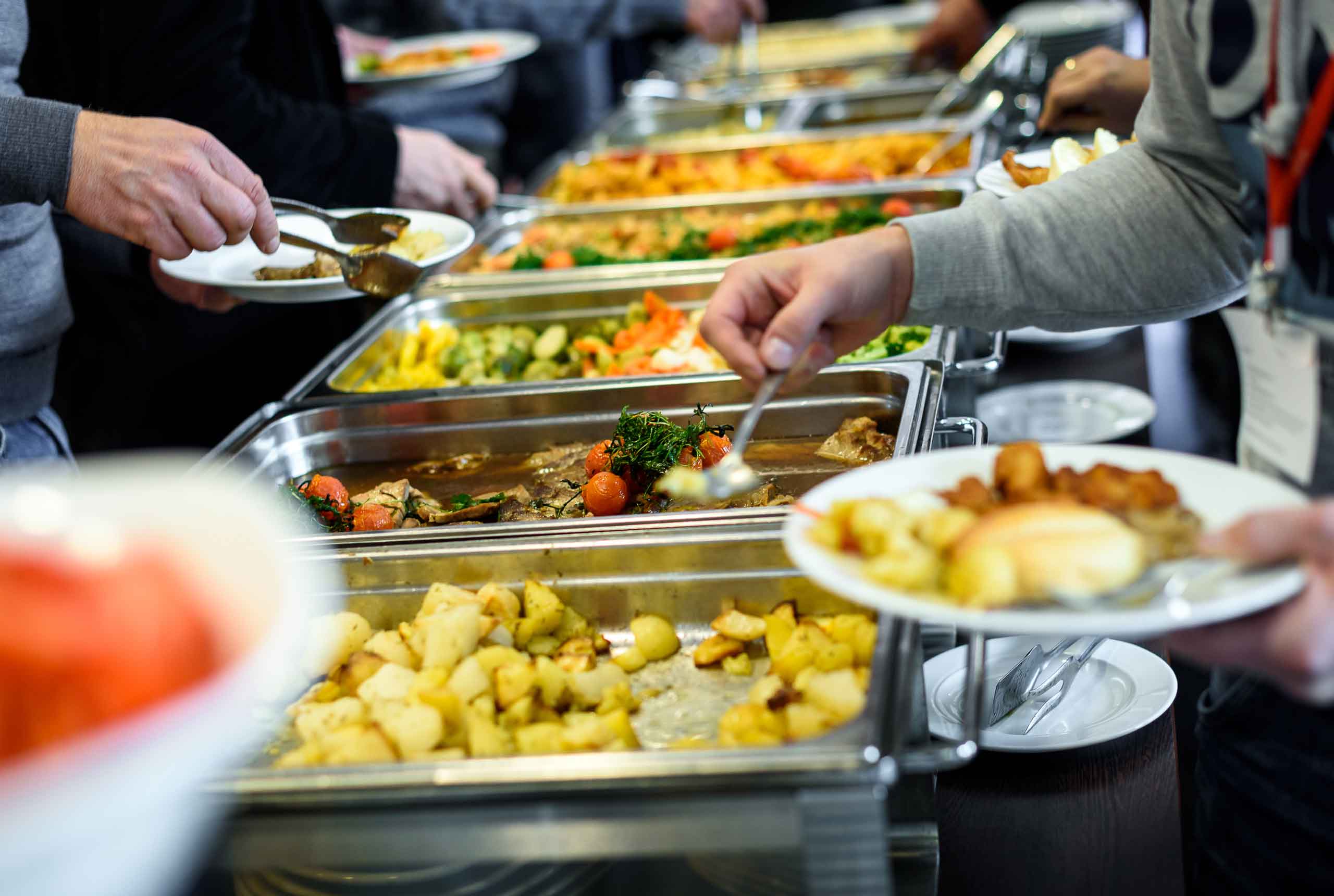 cafeteria buffet table with multiple prepared foods